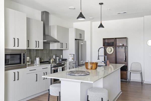 Modern kitchen featuring stainless steel appliances in Starlight Apartments