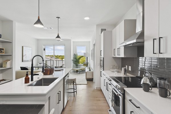 Modern kitchen with sleek countertops and stainless steel appliances at Starlight Apartments