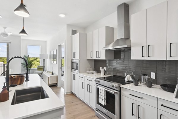 Modern kitchen with stainless steel appliances at Starlight Apartments