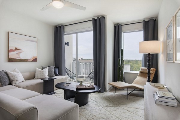 Living room with contemporary decor and ample natural light at Starlight Apartments