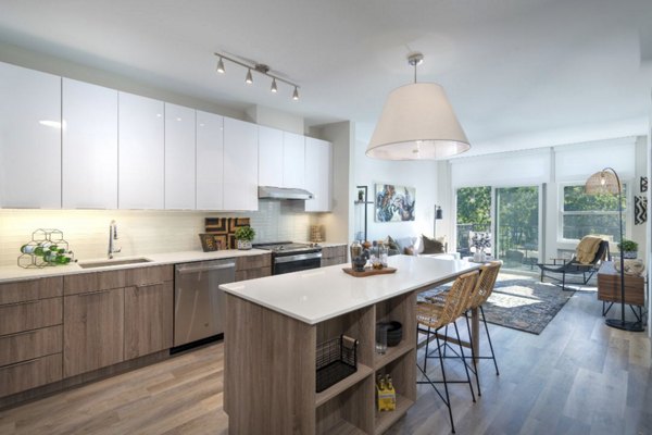 Modern kitchen with stainless steel appliances in Matson Mill Apartments