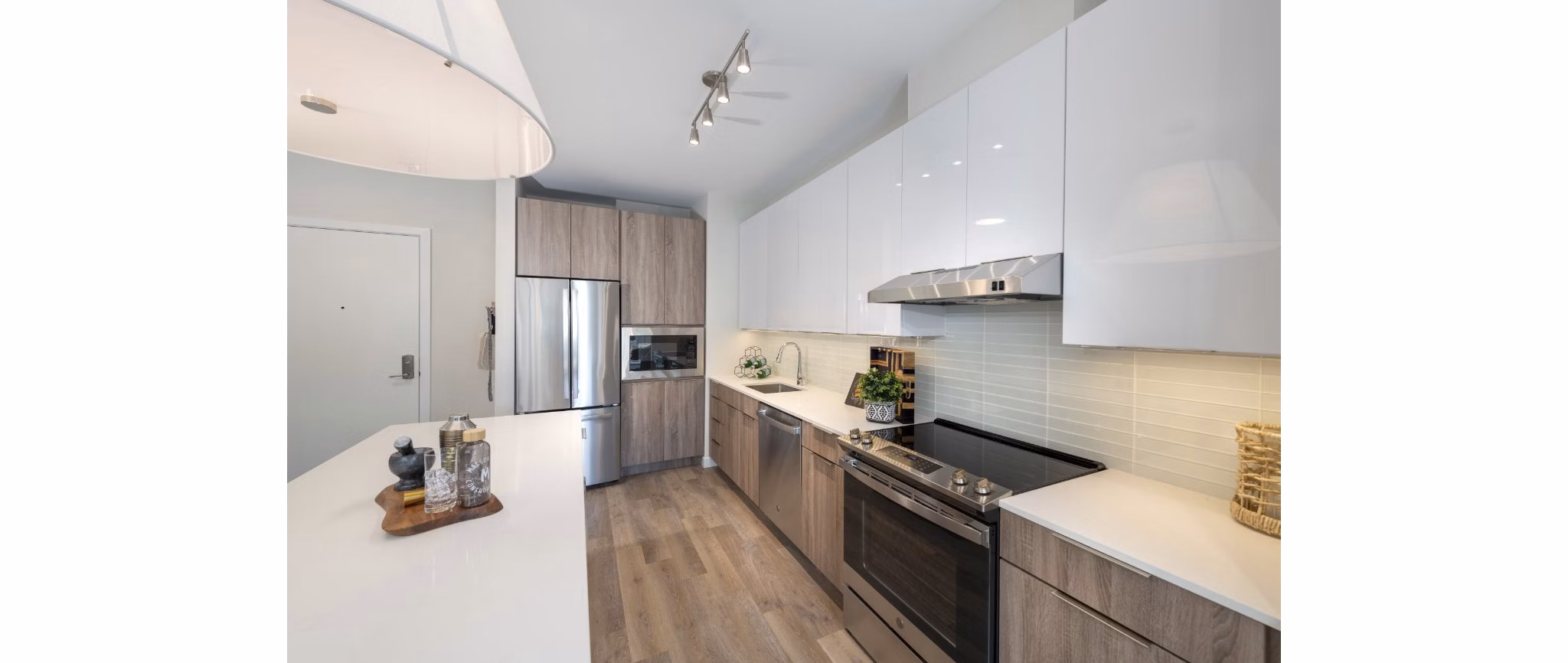 Modern kitchen featuring stainless steel appliances and granite countertops in Matson Mill Apartments