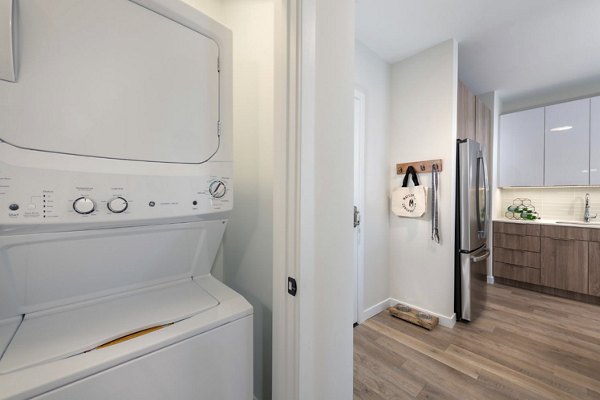 Laundry room featuring modern appliances at Matson Mill Apartments, a Greystar luxury community