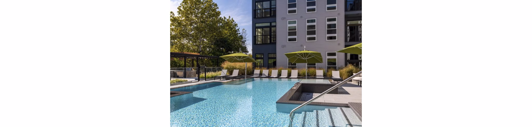 Riverside pool with lounge seating at Matson Mill Apartments