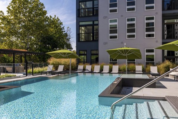 Riverside pool with lounge seating at Matson Mill Apartments