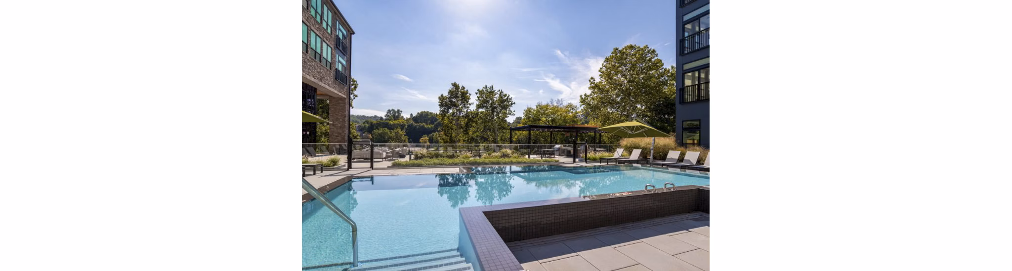 Riverside pool at Matson Mill Apartments offering tranquil outdoor recreation and relaxation with scenic views