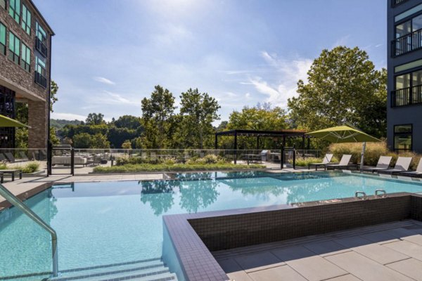 Riverside pool at Matson Mill Apartments offering tranquil outdoor recreation and relaxation with scenic views