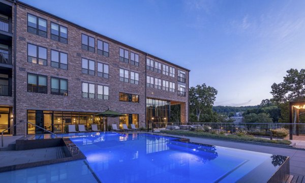 Resort-style pool with sun loungers at Matson Mill Apartments, offering luxury amenities for relaxation and recreation