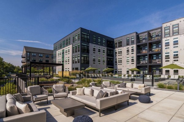 Elegant courtyard with stylish seating and lush greenery at Matson Mill Apartments in a vibrant community setting