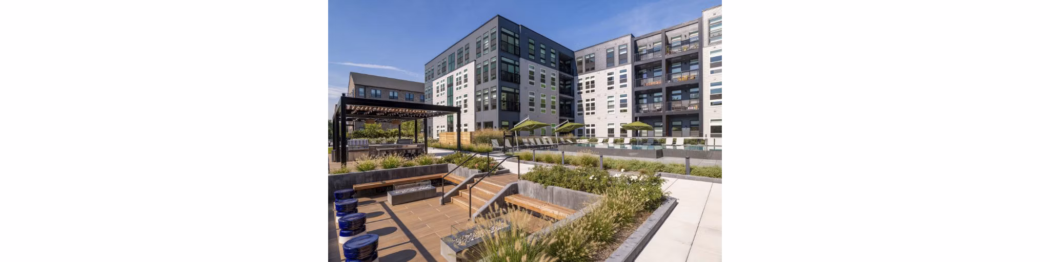 Outdoor courtyard with modern seating and landscaped gardens at Matson Mill Apartments offering luxury living amenities