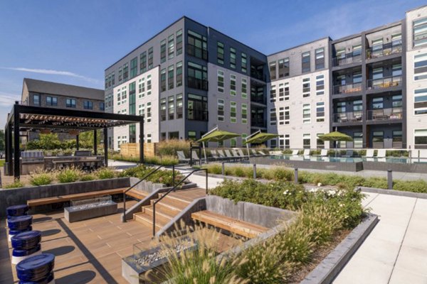 Outdoor courtyard with modern seating and landscaped gardens at Matson Mill Apartments offering luxury living amenities