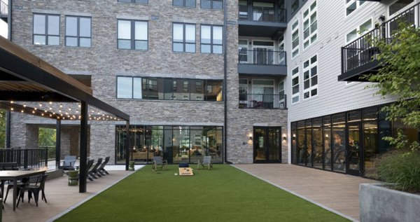 Beautiful courtyard garden with seating areas at Matson Mill Apartments, offering a serene outdoor retreat for residents