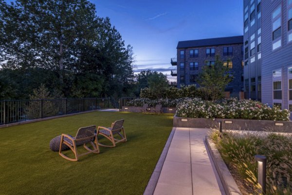 Courtyard featuring lush greenery and seating areas at Matson Mill Apartments