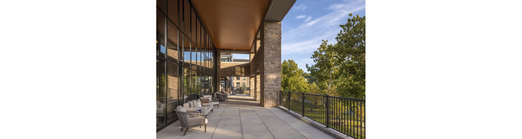 Relaxing furnished patio with garden views at Matson Mill Apartments luxury community