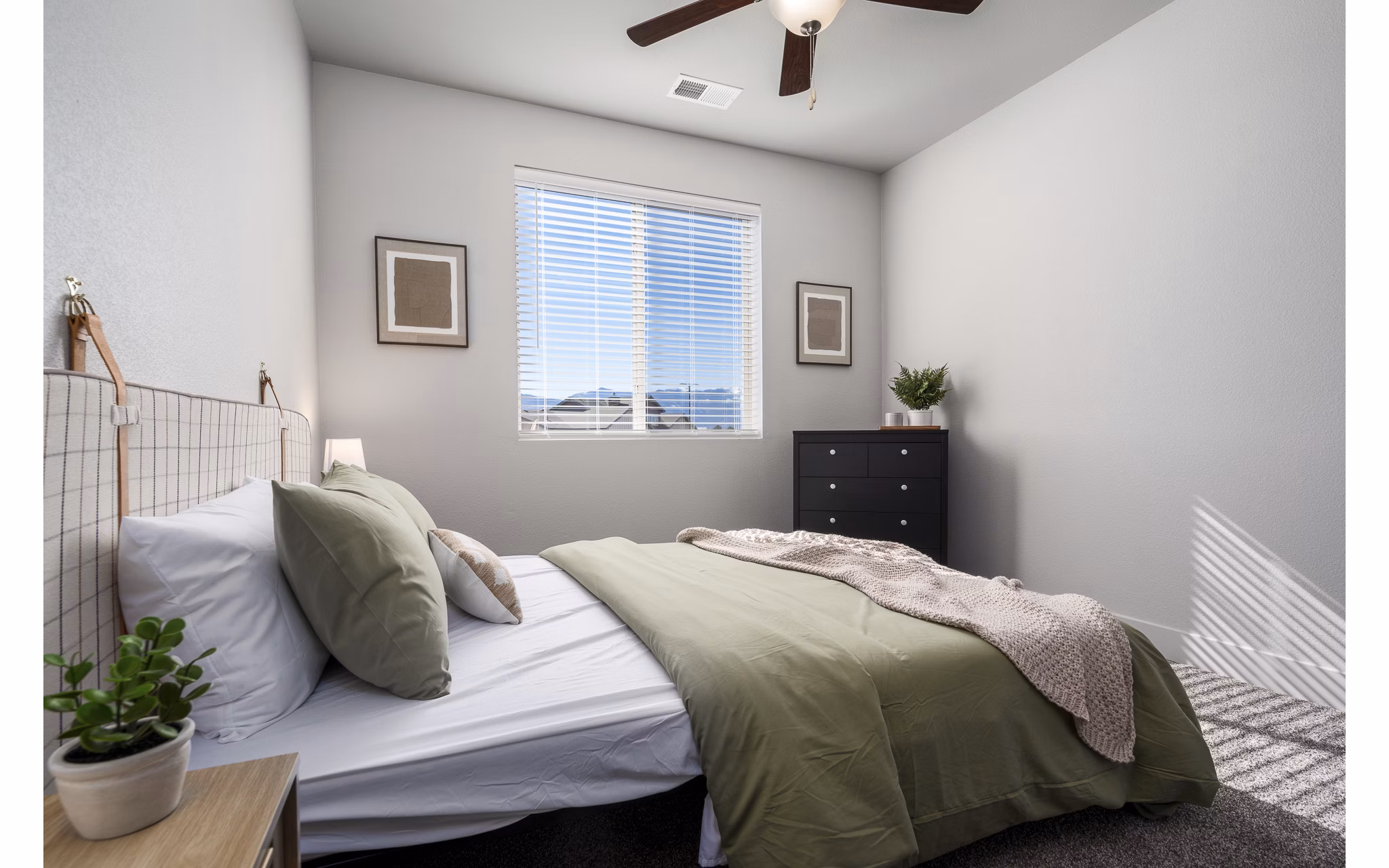 Cozy bedroom featuring stylish modern furniture at The Flats at Aero Park Apartments