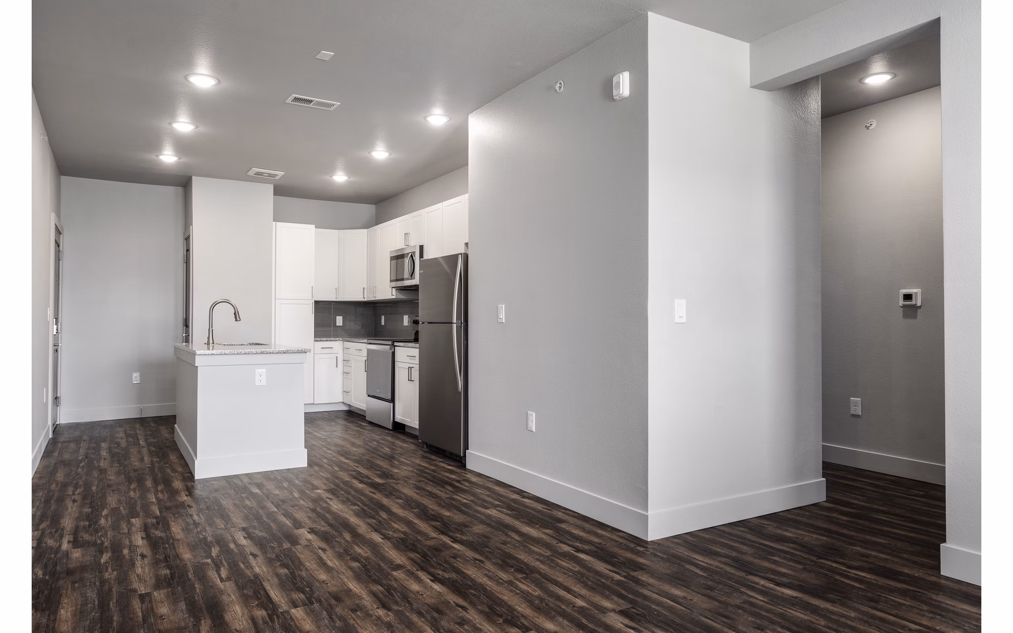 Modern kitchen with stainless steel appliances in The Flats at Aero Park Apartments