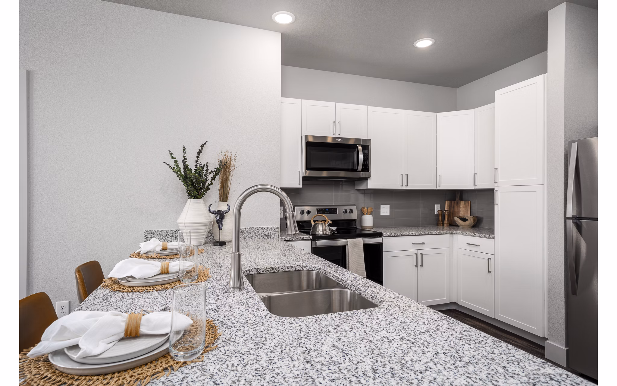 Modern kitchen with stainless steel appliances at The Flats at Aero Park Apartments