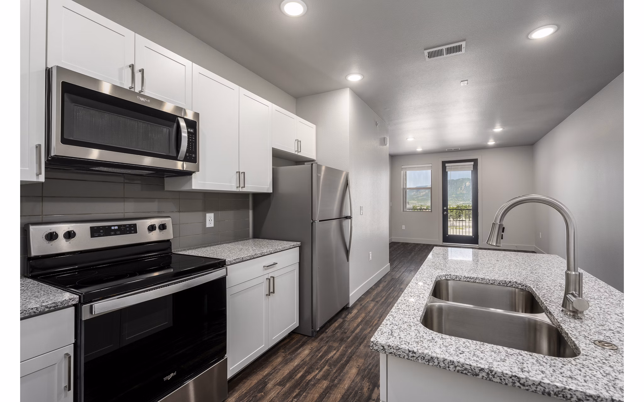 The Flats at Aero Park: Modern kitchen with sleek countertops and stainless steel appliances