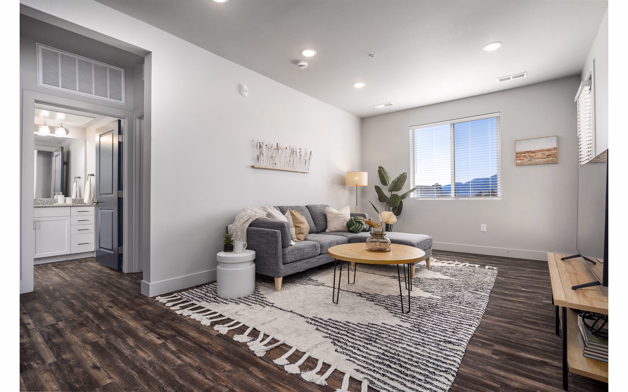 Living room with modern design and large windows at The Flats at Aero Park Apartments
