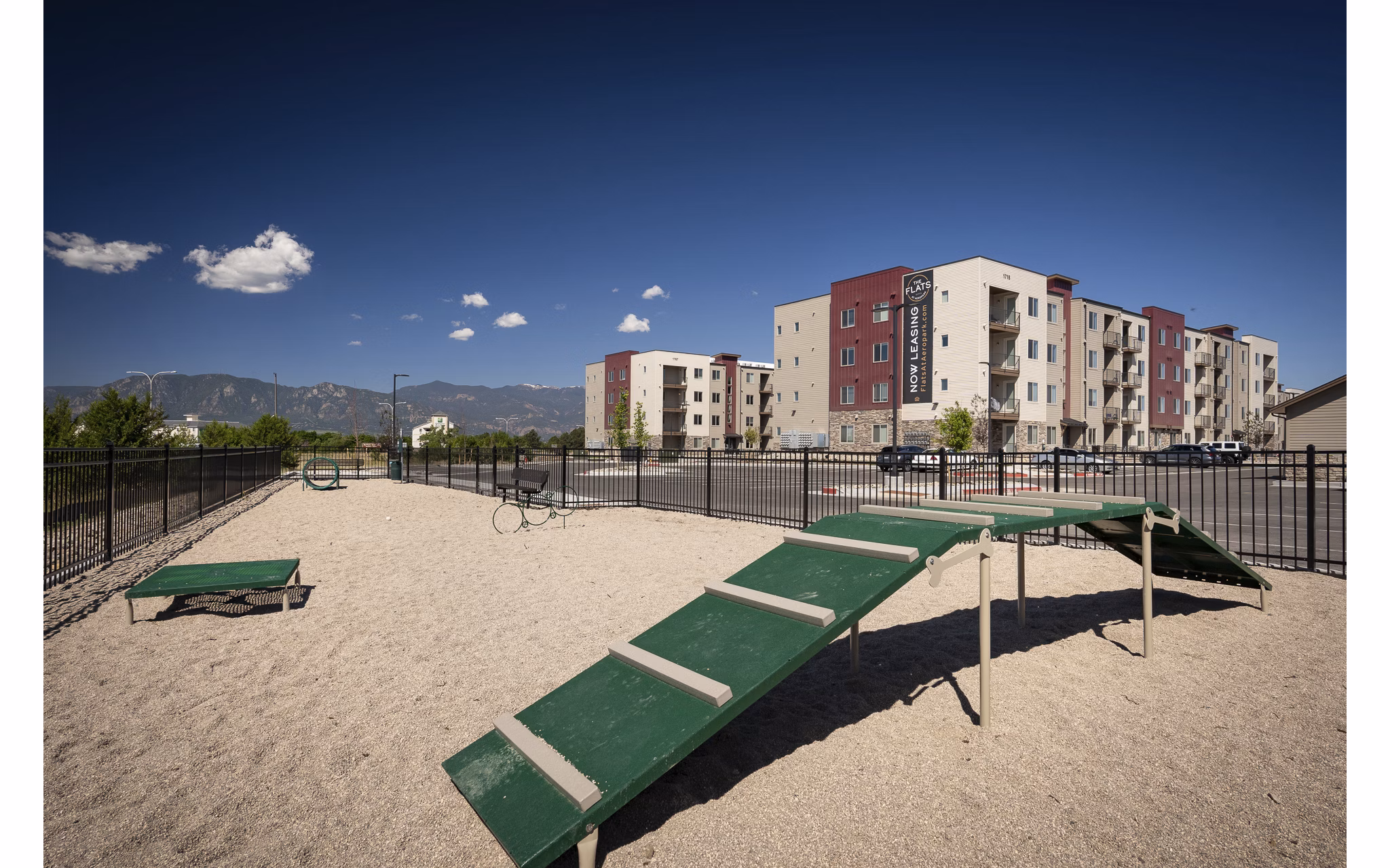 Dog-friendly park featuring agility equipment at The Flats at Aero Park Apartments