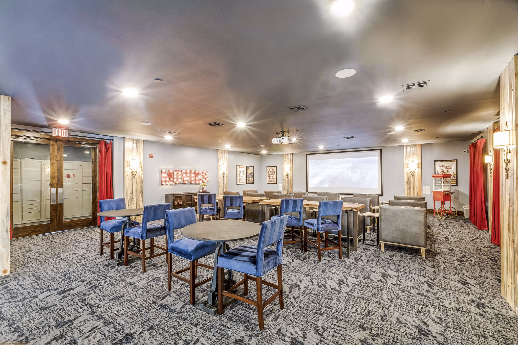 Clubhouse movie theater with plush seating at Alders Cross Creek Apartments, ideal for private screenings and community events