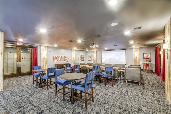 Clubhouse movie theater with plush seating at Alders Cross Creek Apartments, ideal for private screenings and community events