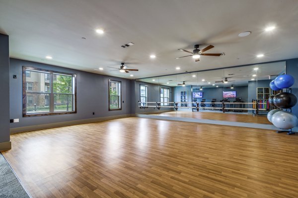 Serene yoga studio with hardwood floors and natural light at Alders Cross Creek Apartments