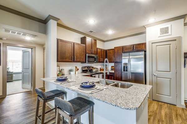 Contemporary kitchen featuring sleek countertops and stainless appliances in Alders Cross Creek Apartments