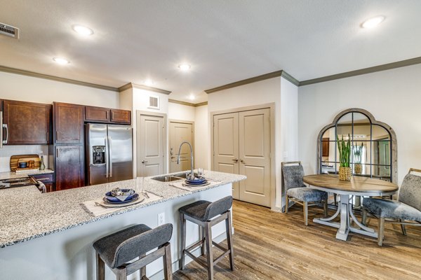 Modern kitchen with stainless steel appliances at Alders Cross Creek Apartments