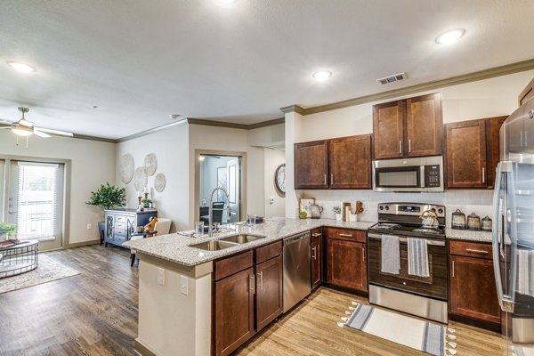 Modern kitchen with stainless steel appliances in Alders Cross Creek Apartments