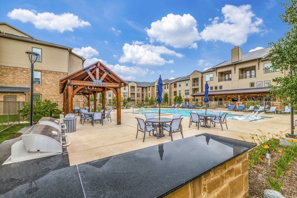 Spacious pool patio with modern seating at Alders Cross Creek Apartments, perfect for relaxation and social gatherings