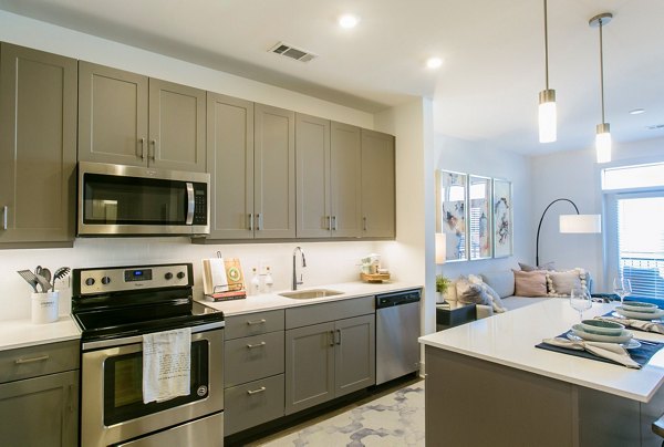 Modern kitchen with stainless steel appliances in Bradham at New Bern Apartments