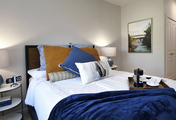 Cozy bedroom with stylish decor in The Aspens Verdae Apartments, showcasing luxury living in Greenville