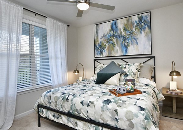 Cozy bedroom featuring modern decor and natural lighting at The Aspens Verdae Apartments