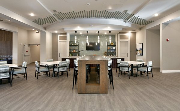 Dining area with modern furnishings at The Aspens Verdae Apartments, featuring elegant lighting and spacious seating for a luxurious experience