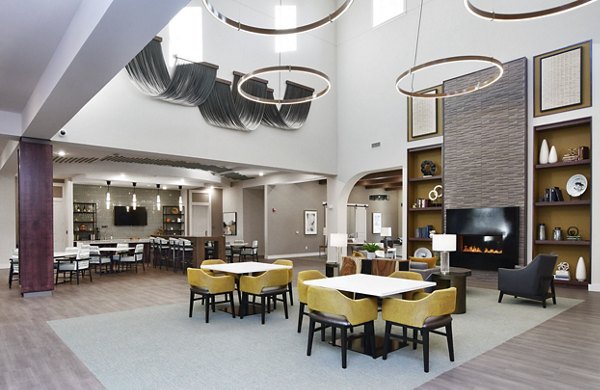 Dining area featuring elegant wooden furnishings and modern lighting at The Aspens Verdae Apartments