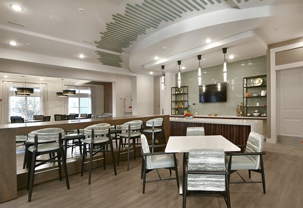 Dining area with elegant wooden furniture at The Aspens Verdae Apartments, showcasing modern luxury living