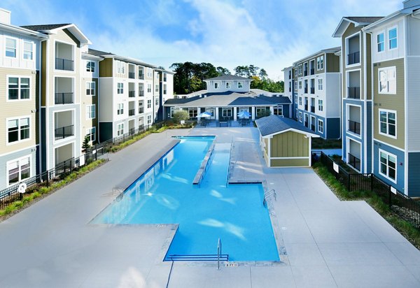 Inviting poolside oasis at The Aspens Verdae Apartments with luxurious lounge chairs and scenic views for relaxation