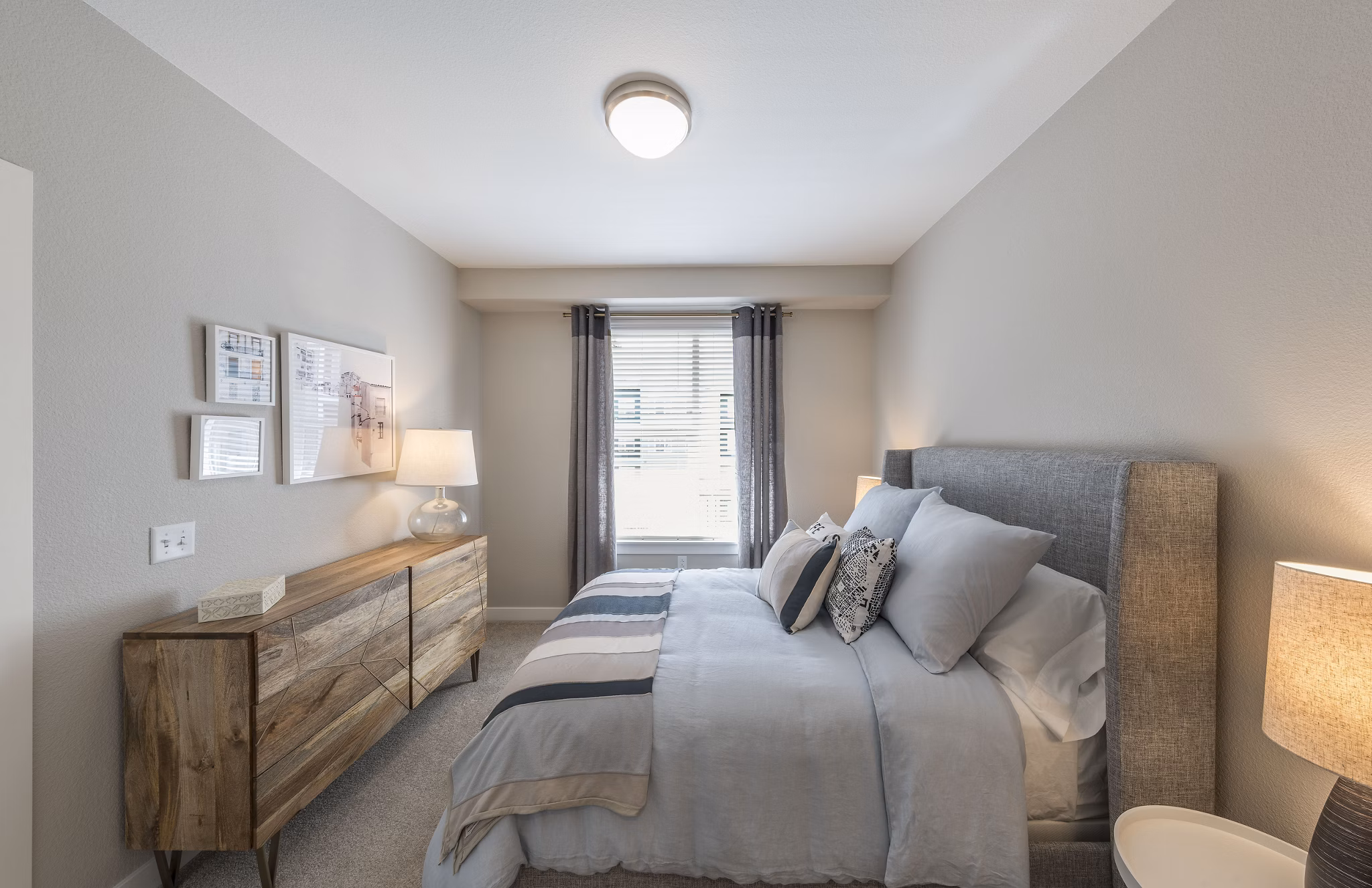 Bedroom featuring modern decor and large windows in Beacon 85 Apartments