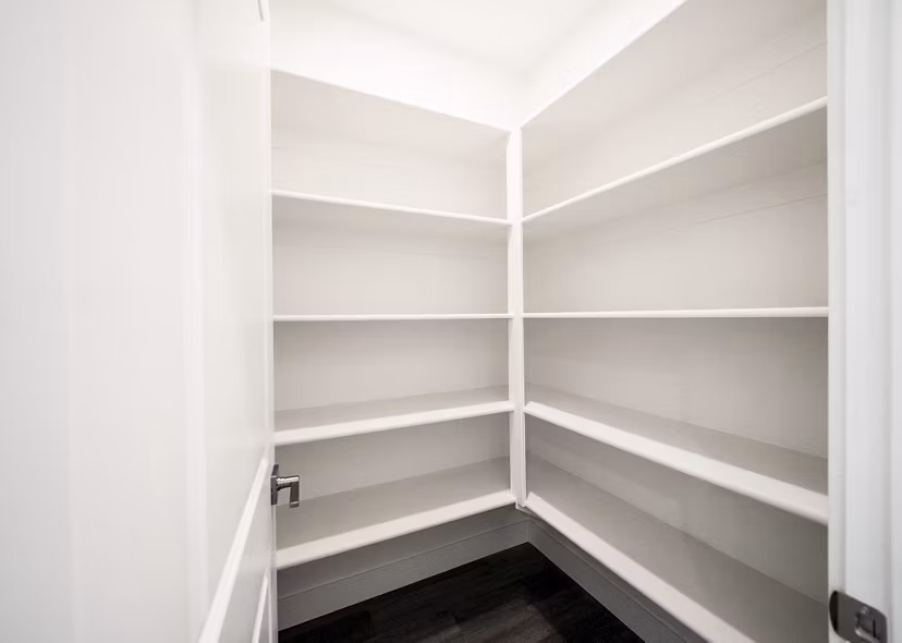 Walk-in closet with custom shelving in Klein Huis at Turner Mill Apartments
