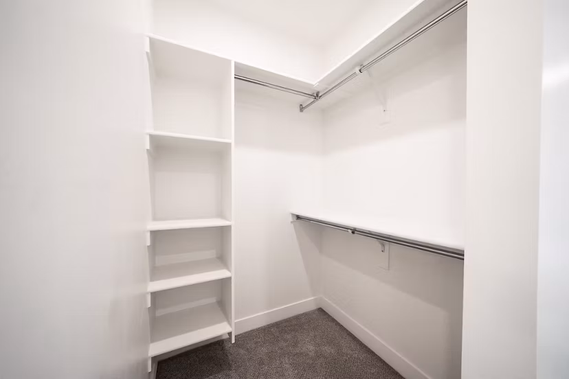 Walk-in closet with modern shelving in Klein Huis at Turner Mill Apartments