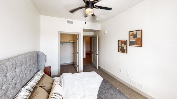 Cozy bedroom with modern decor at Sequoia Apartments in Turner Mill, offering a comfortable living space in a luxury apartment setting