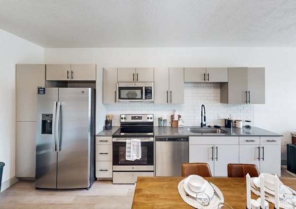 Modern kitchen with stainless steel appliances at Sequoia Apartments, Turner Mill Open concept design featuring luxury finishes and island counter