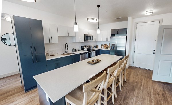 Modern kitchen featuring stainless steel appliances and granite countertops at Sequoia Apartments at Turner Mill