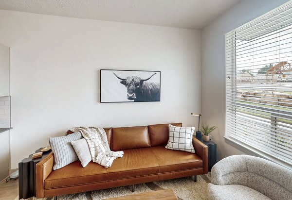 Spacious living room with modern decor in Sequoia Apartments at Turner Mill, perfect for comfort and style