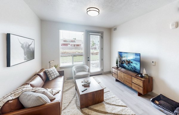 Spacious living room with modern decor in Sequoia Apartments at Turner Mill