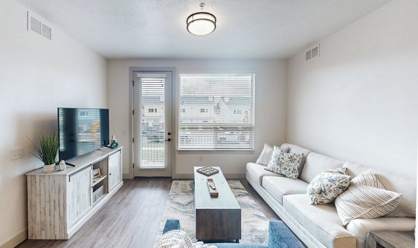 Spacious living room with modern decor in Sequoia Apartments at Turner Mill Apartments