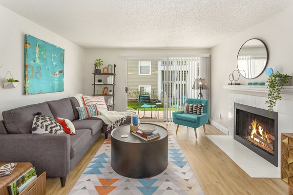 Cozy living room with plush seating and natural light in Alaire Apartment Homes, luxury living by Greystar