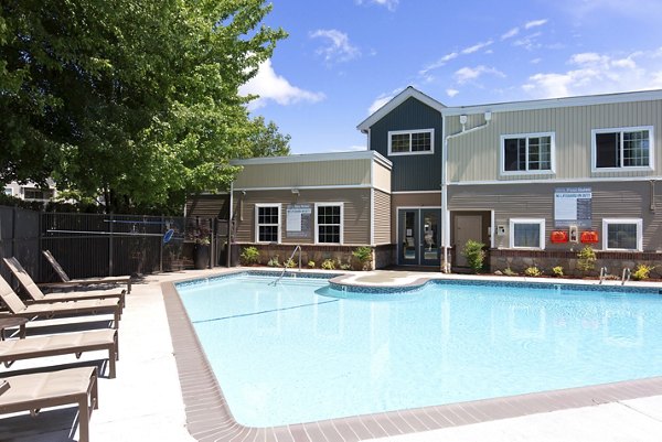 Outdoor pool with poolside seating at Alaire Apartment Homes Apartments