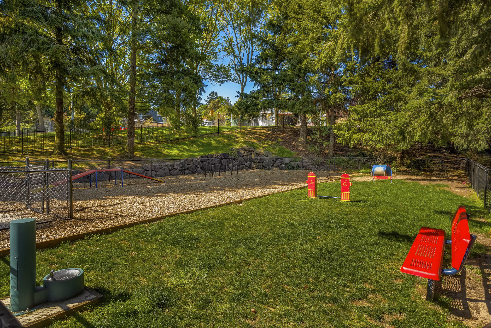 Modern playground with colorful equipment at Alaire Apartment Homes apartments, ideal for family-friendly outdoor activities in a welcoming community